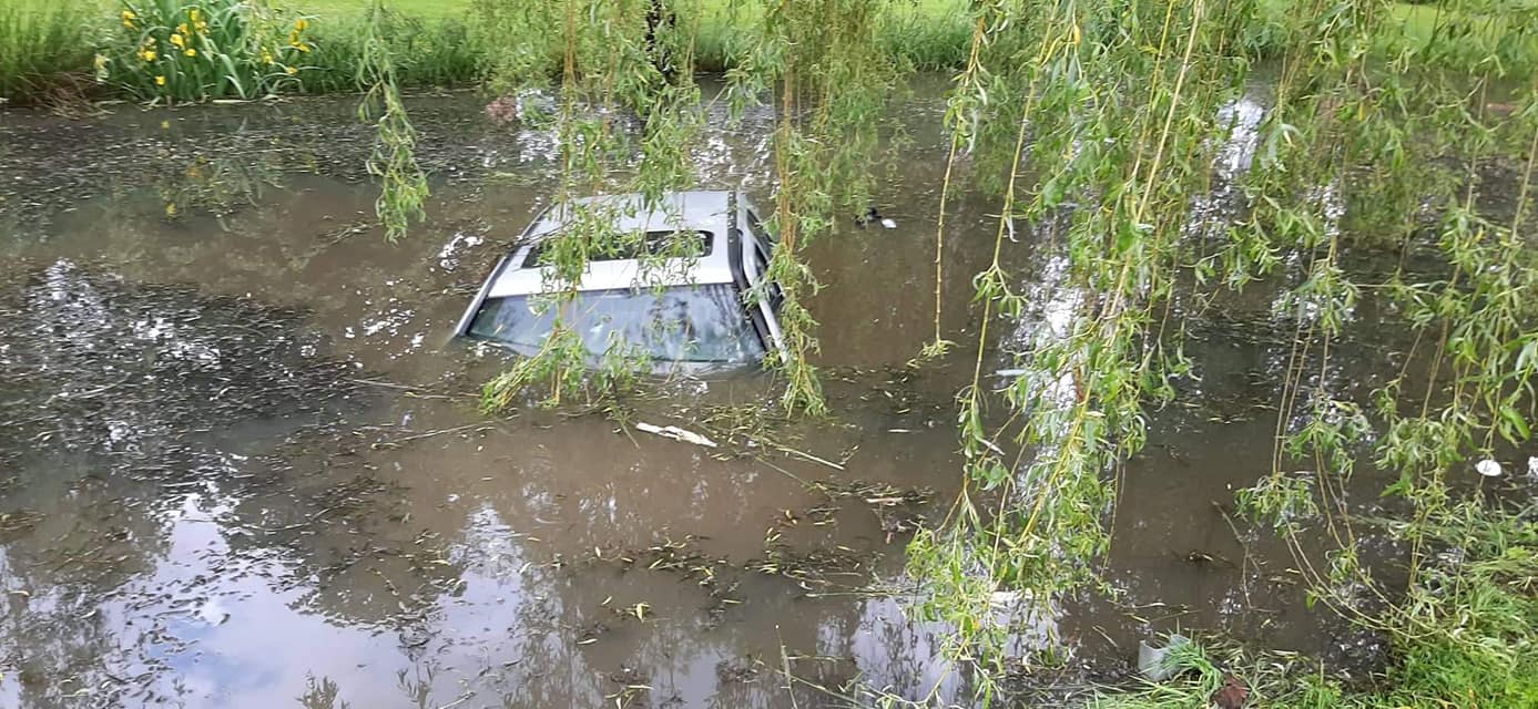 FOTO: Po trčenju dveh vozil eno pristalo v jarku, drugo v ribniku